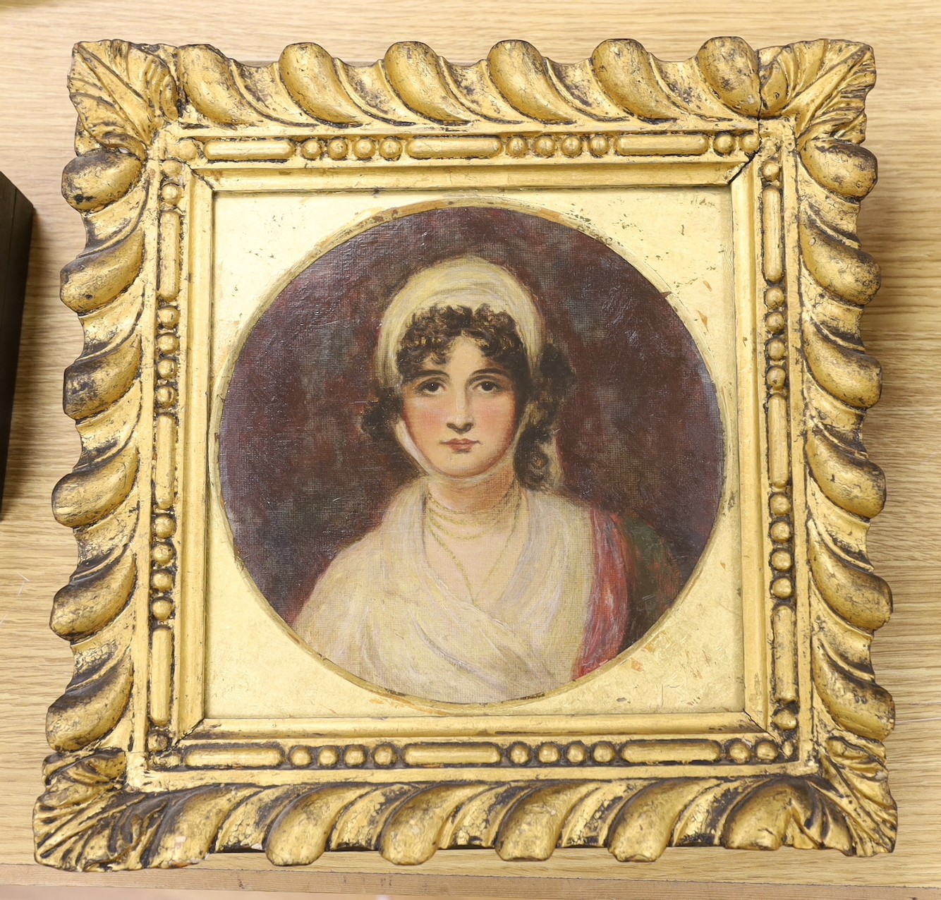 19th century English School, oil on canvas laid on board, Portrait of a lady, tondo, 20cm